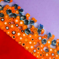Close-up of a red, purple and orange serving dish