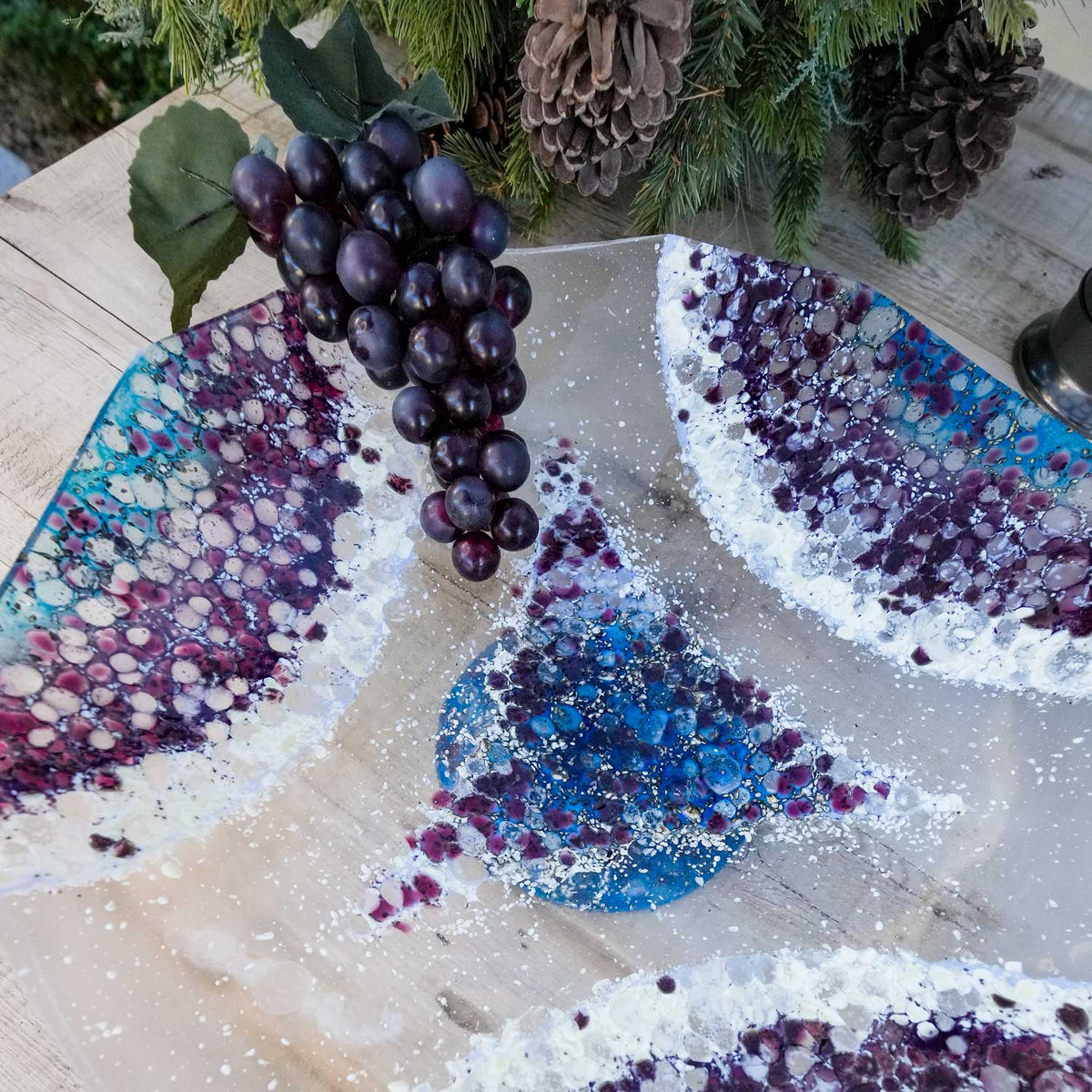Close-up of a beautiful purple, blue and clear serving pedestal bowl.