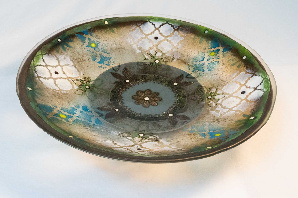 Handmade glass bowl with pattern design of blue, green white, and grey.